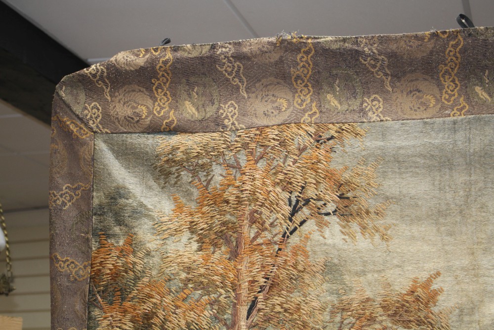 A 20th century Japanese silk panel, depicting wolves hunting geese beside a woodland stream, the inner panel 173 x 115cm, overall 205 x